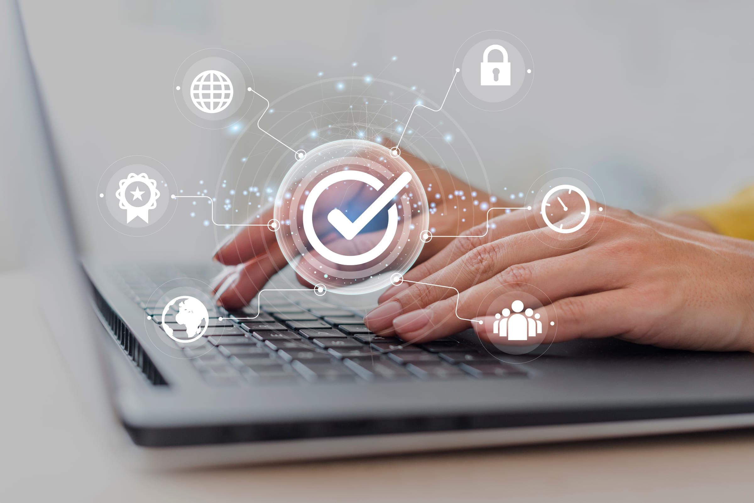 Hands typing on a laptop keyboard overlaid with data-security and privacy icons