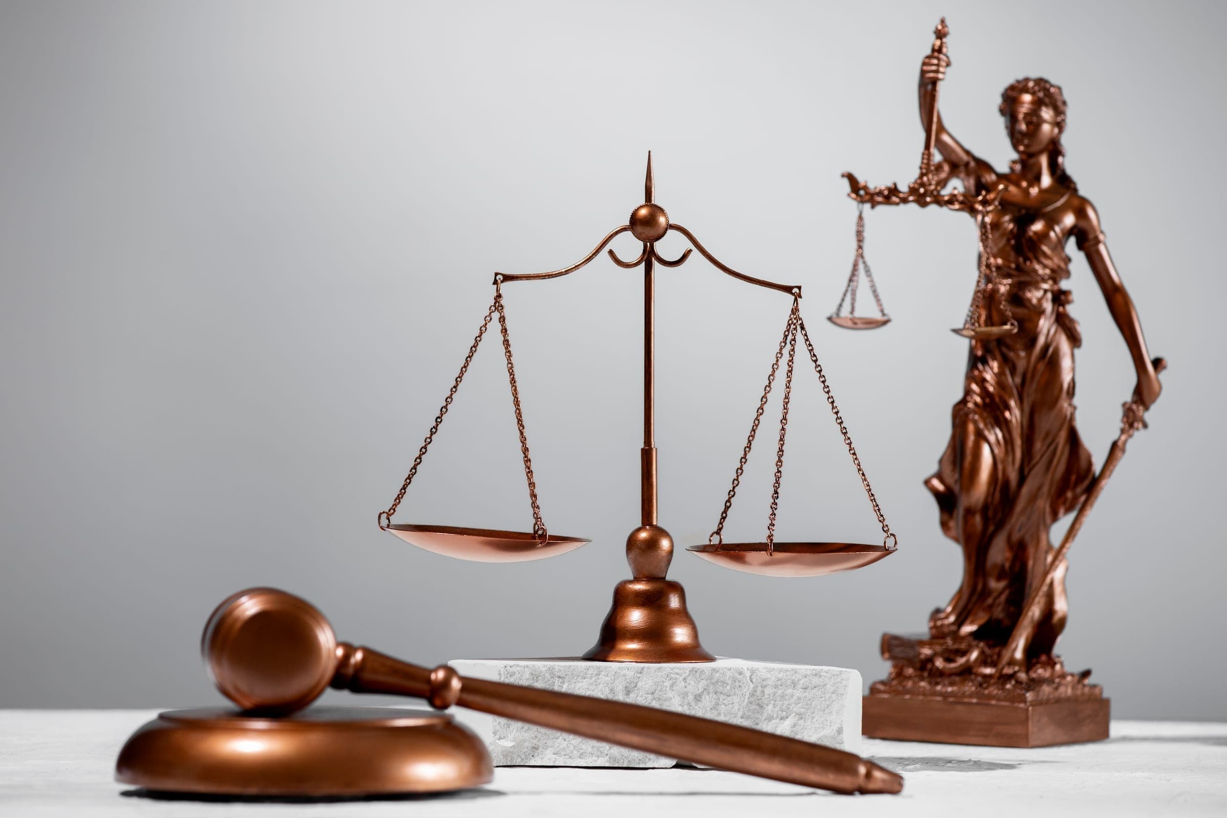 Bronze scales of justice, a gavel and a Lady Justice statue